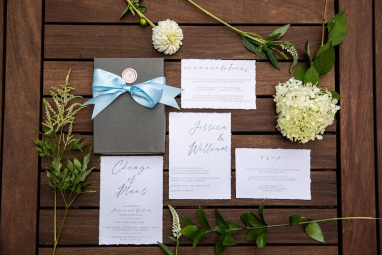A beautiful wedding invitation suite with greenery and flowers