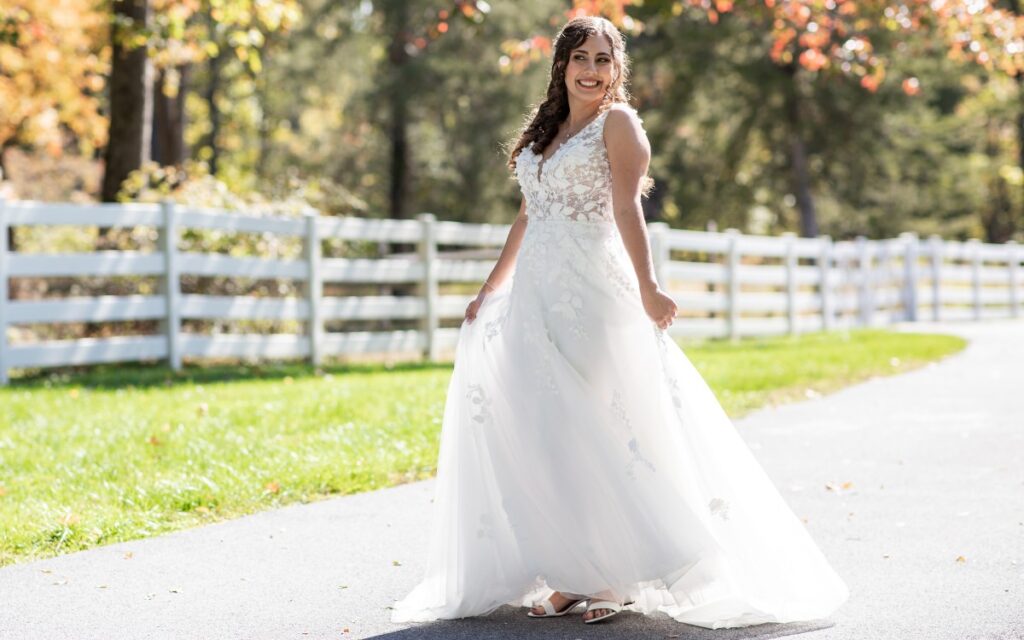 A bride showing off her wedding dress outside