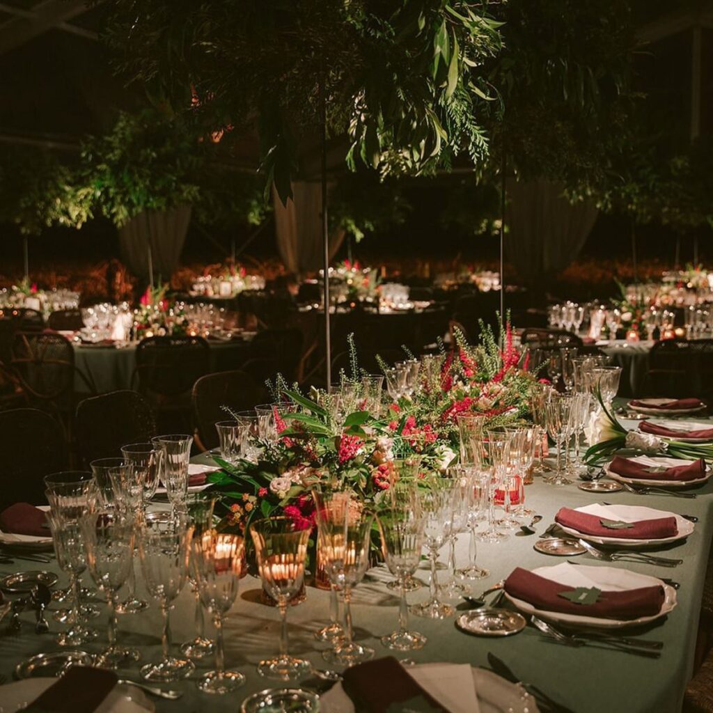 An elegant wedding reception centerpiece and table layout for a Christmas-inspired wedding