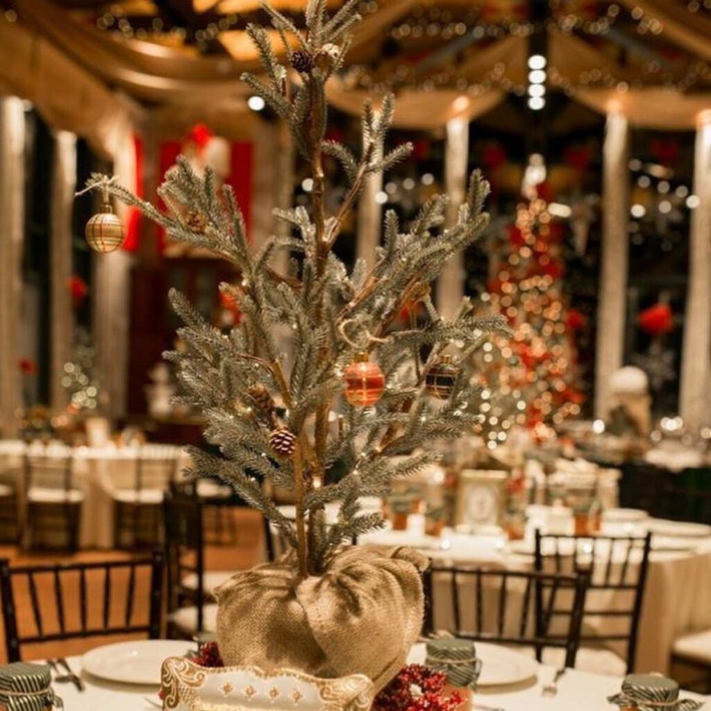A mini Christmas tree being used as a reception centerpiece for a Xmas wedding