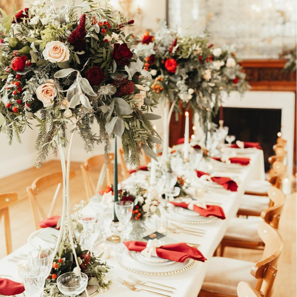 Tall Christmas wedding flowers being used as centerpieces 