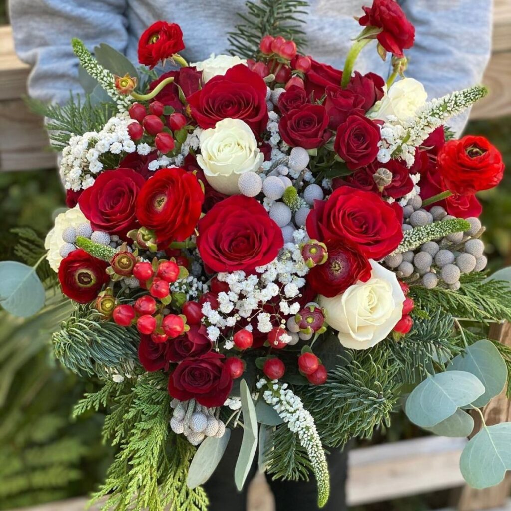 A closeup photo of a Christmas wedding bouquet. This is for the blog post called Christmas Wedding Flowers