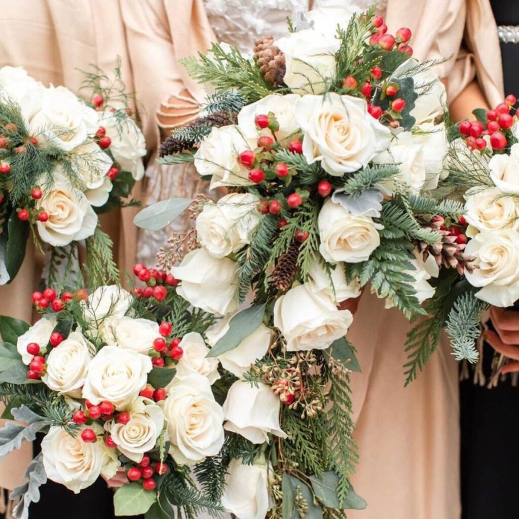 A photo of a Christmas-themed bridal bouquet and a few bridesmaids bouquets