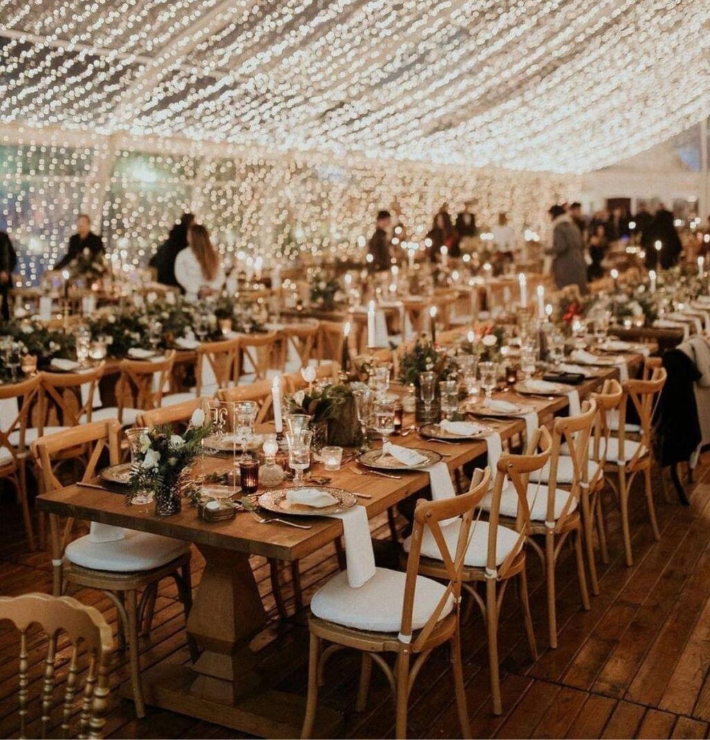Long wedding reception tables with candles and small centerpieces