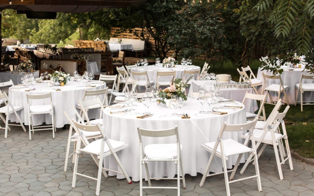 A wedding table, chair, and linens showing wedding items that can be rentals.