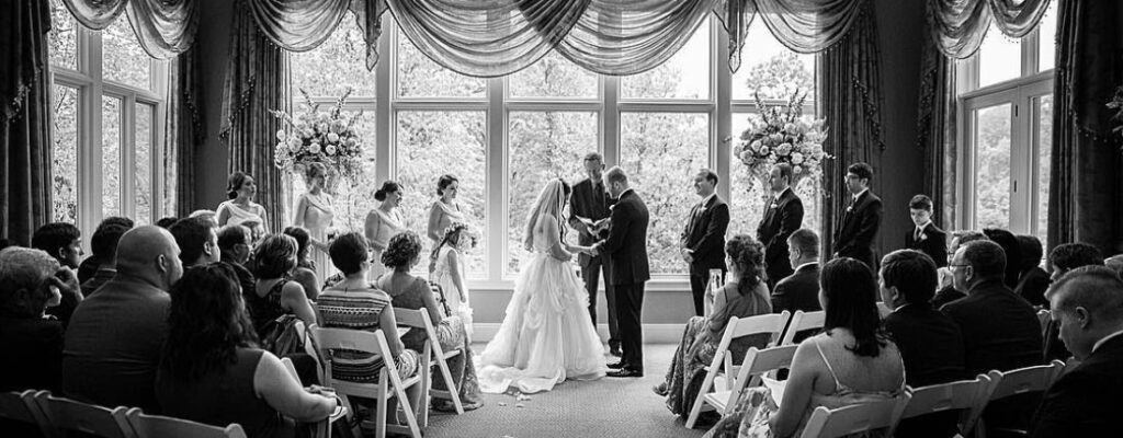 A wedding ceremony taking place in the living room of a private residence.