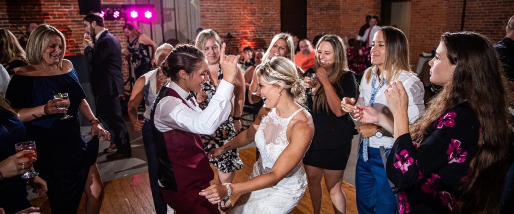 Two brides dancing on the dance floor at their wedding reception