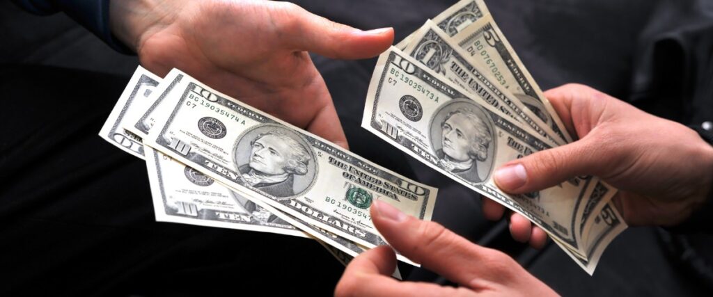A photo of someone paying someone else money