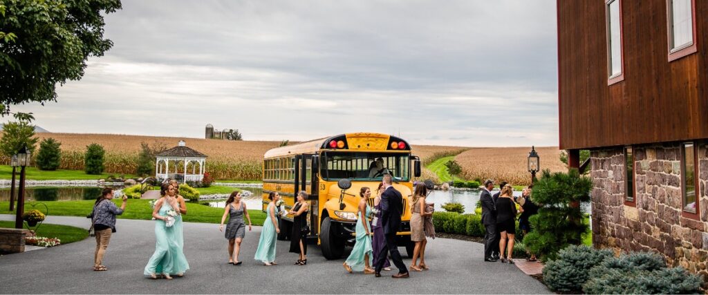 A yellow school bus dropping off guests at a wedding.