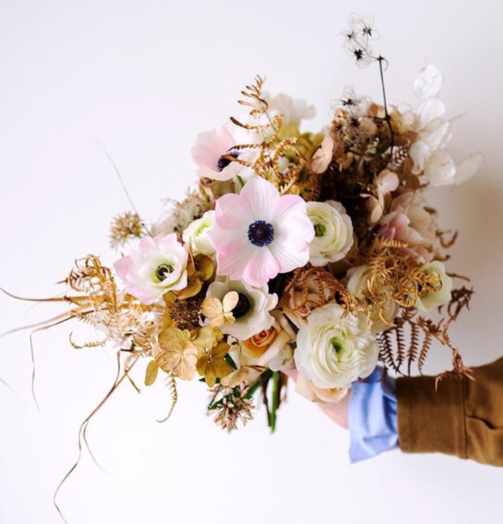 A close up of a bridal bouquet with big pink flowers