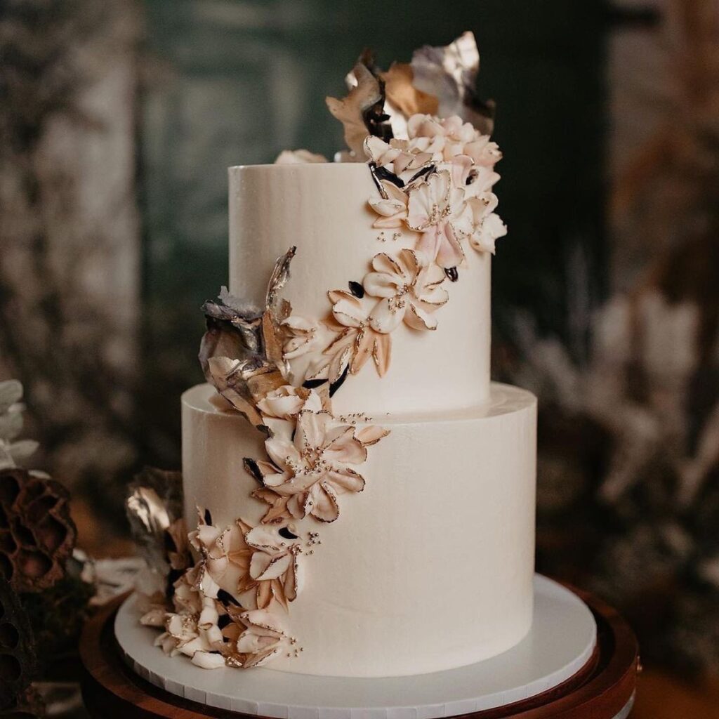 A 2-tier winter wedding cake with beautiful cascading flowers