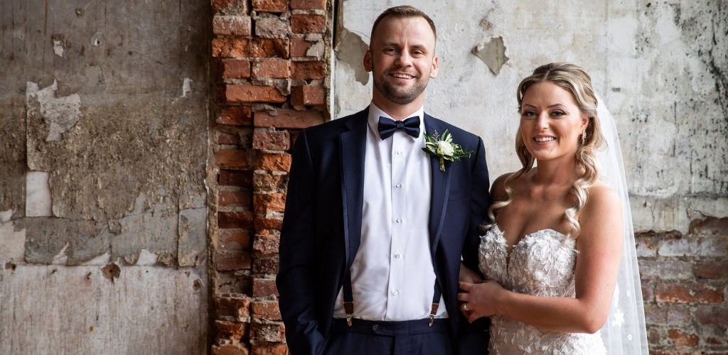 A bride and groom posing together on their wedding day