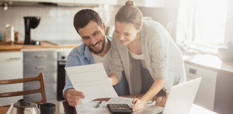 A couple going over their wedding budget in their home