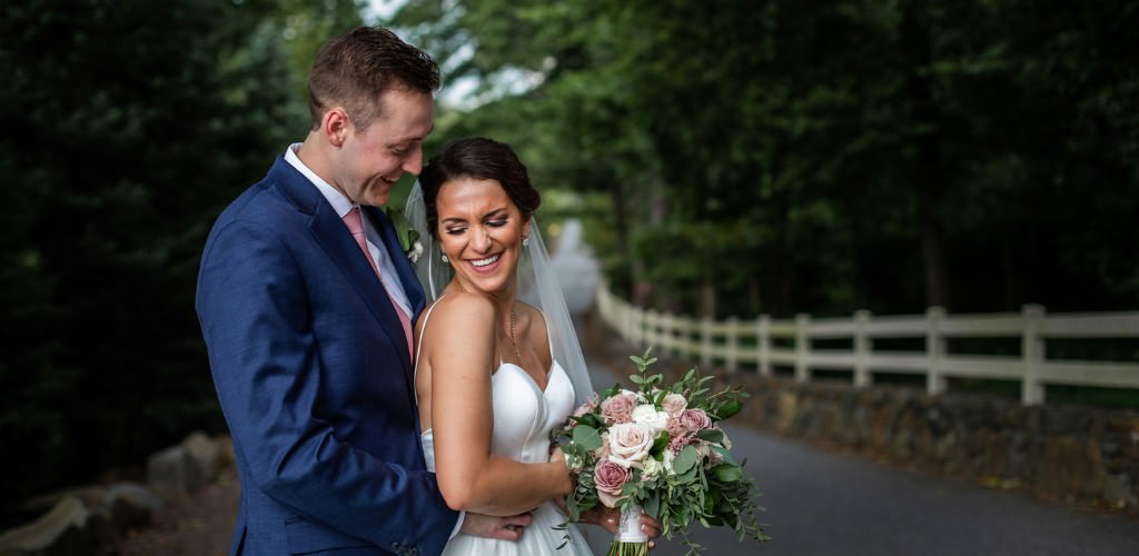A bride being held close by a groom