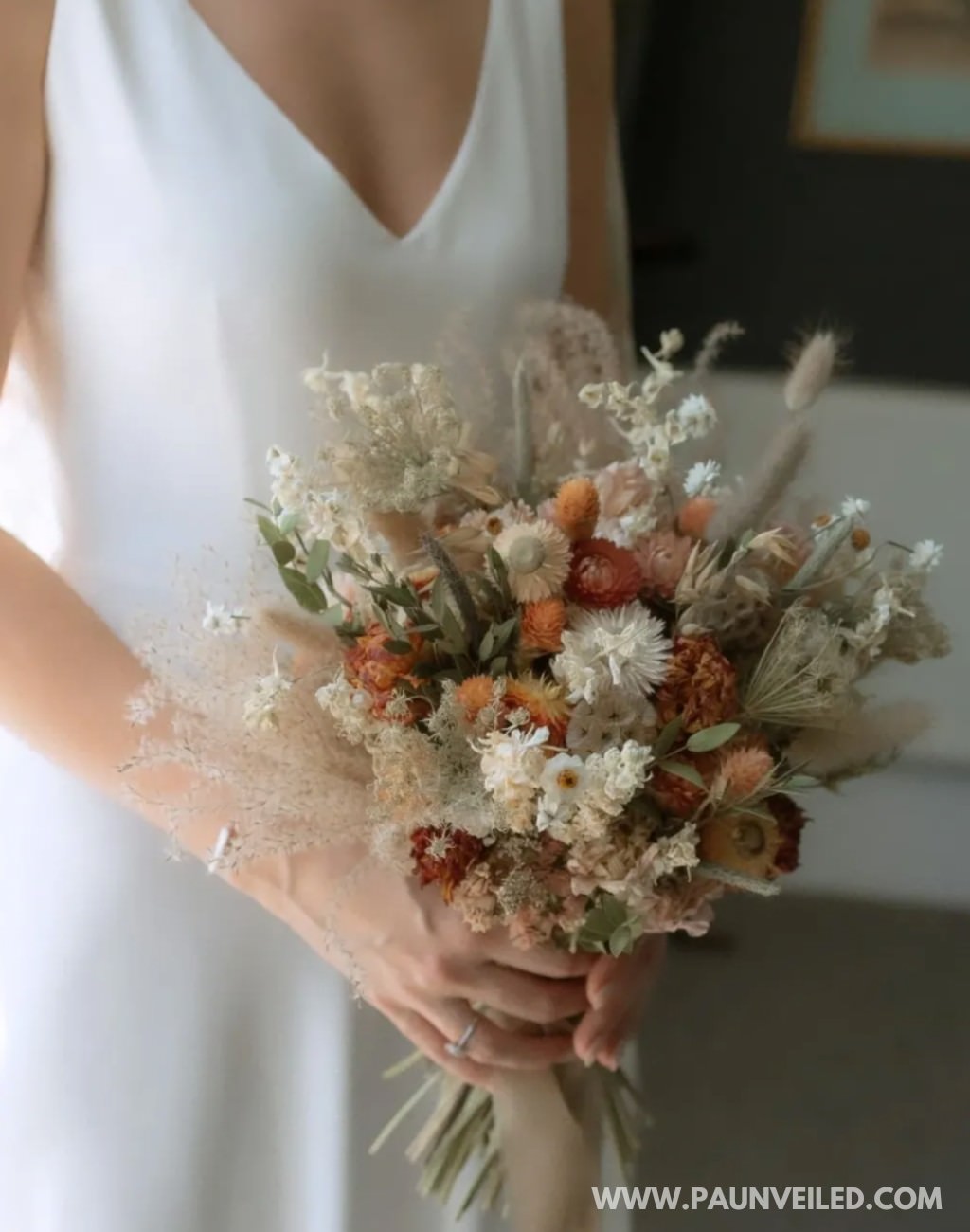 A small rustic bridal bouquet made with dried flowers