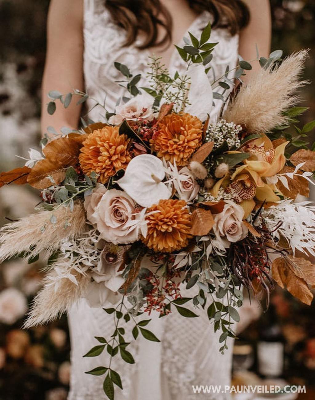 A stunning rustic wedding bouquet for the bride made with burnt orange and rust flowers