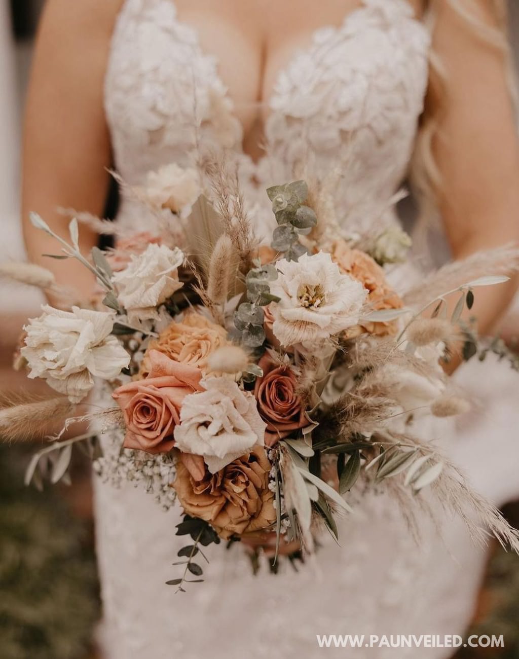 A rustic wedding bouquet being held by the bride