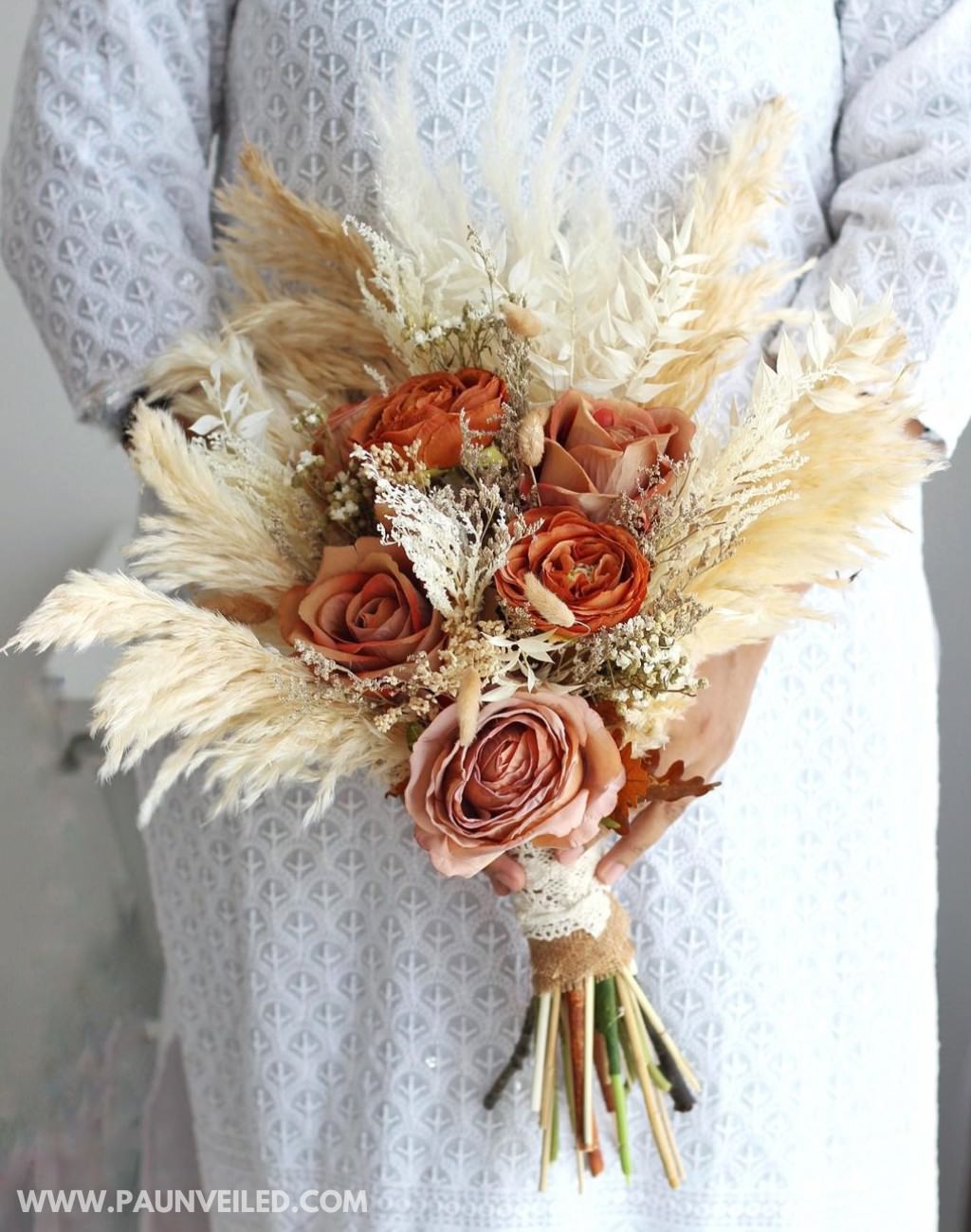 A beautiful bridal bouquet with a rustic look. This bouquet uses dried flowers and wheat grass
