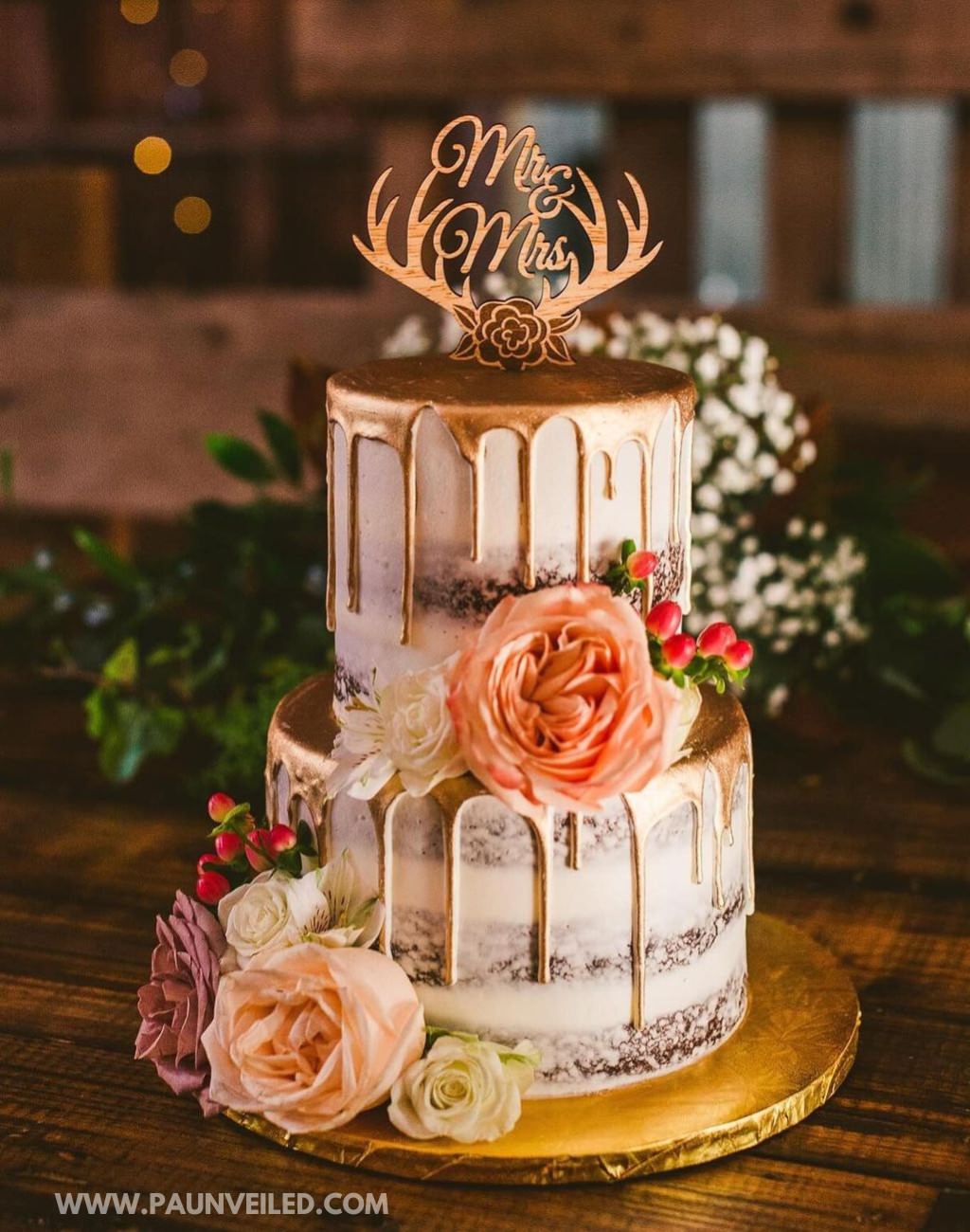 A wedding cake with deer antler cake topper