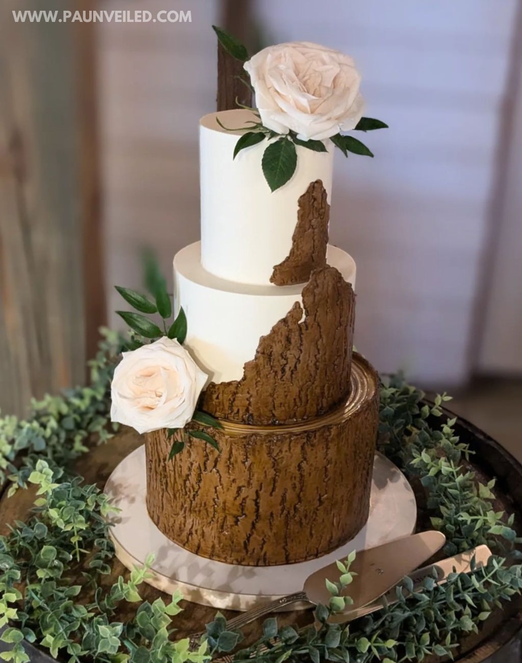 A 3-tier rustic wedding cake with tree bark texture