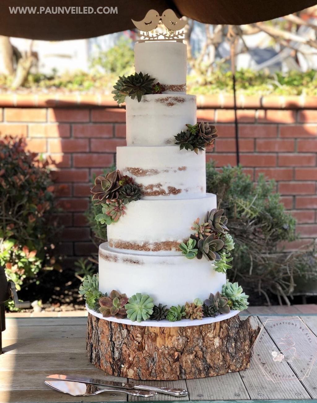 A 5-tier semi-naked rustic wedding cake with succulents