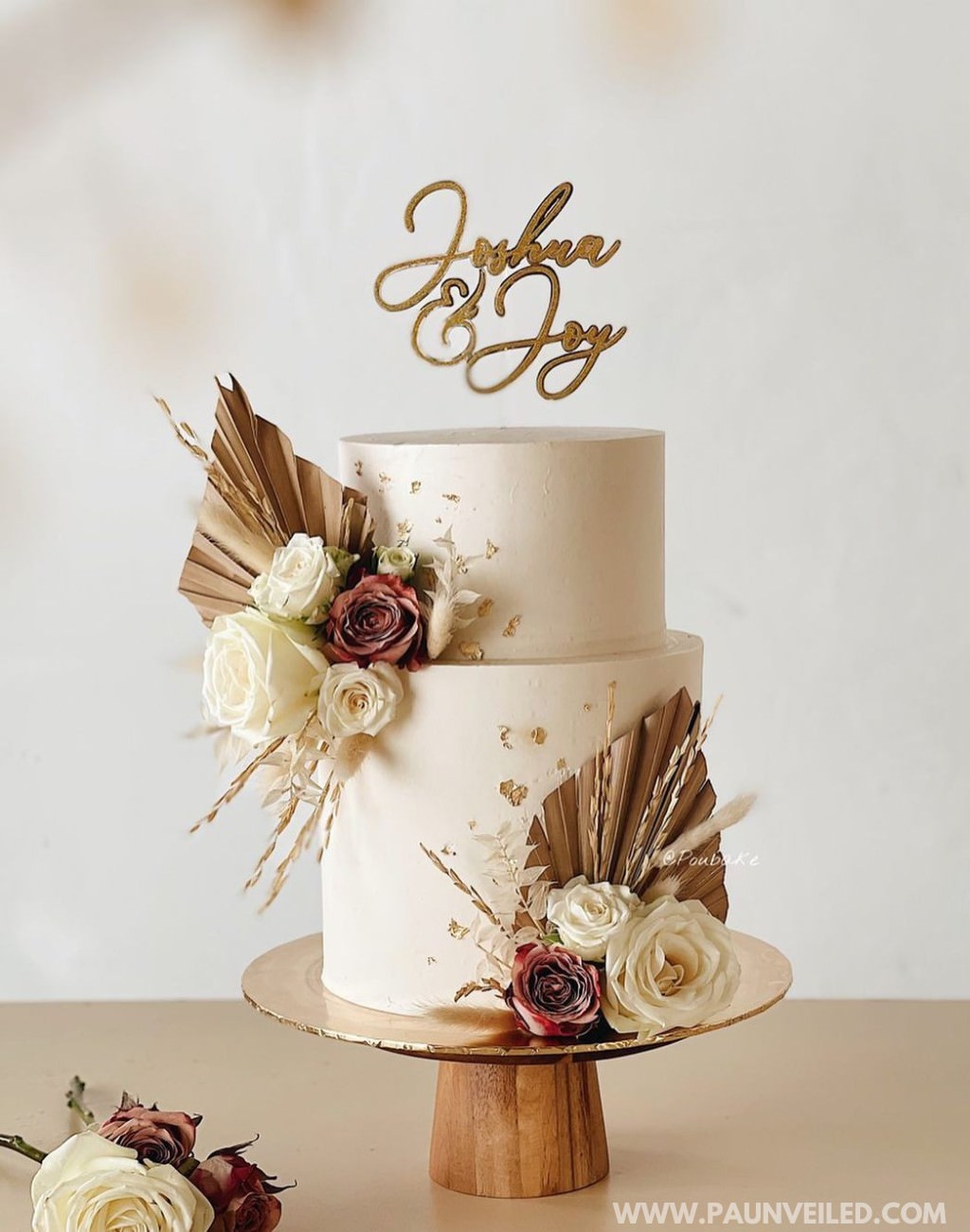 A modern rustic wedding cake with white frosting