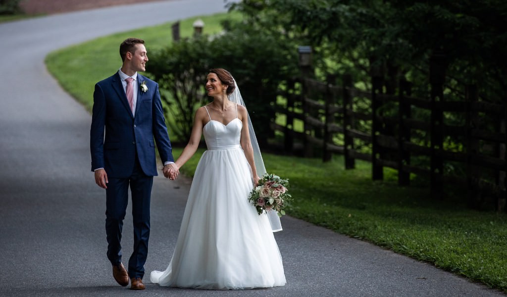 A bride and groom taking a quiet walk together on their wedding day