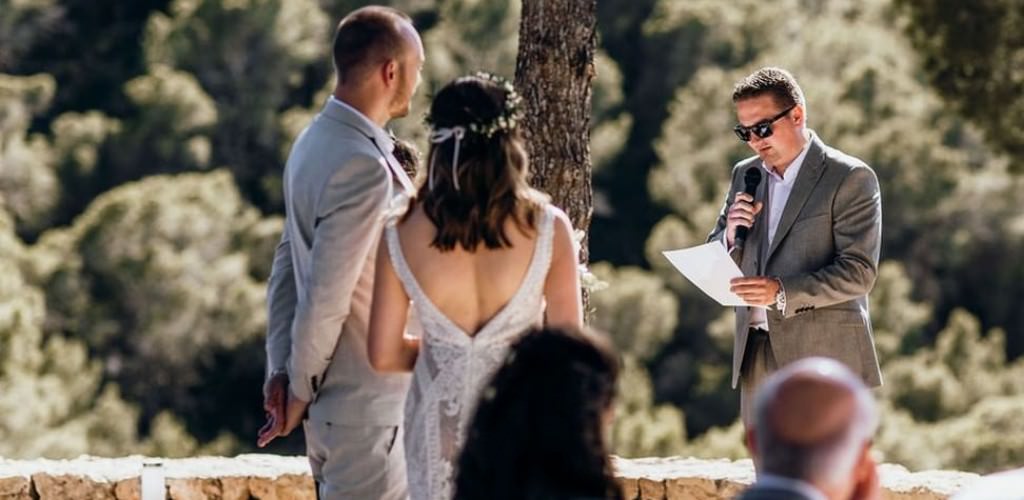 A fmaily member doing a special reading for the bride and groom at a wedding ceremony