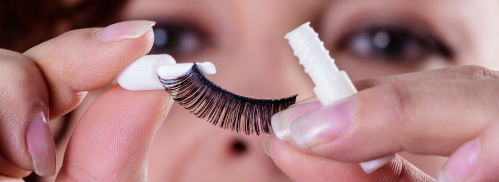 A bride putting eyelash glue on her fake lashes