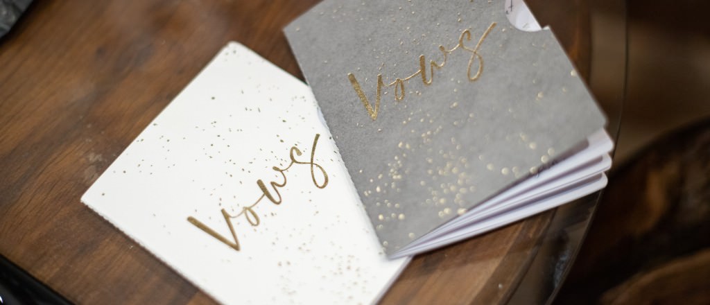 Two wedding vows books that say "Vows" on the cover