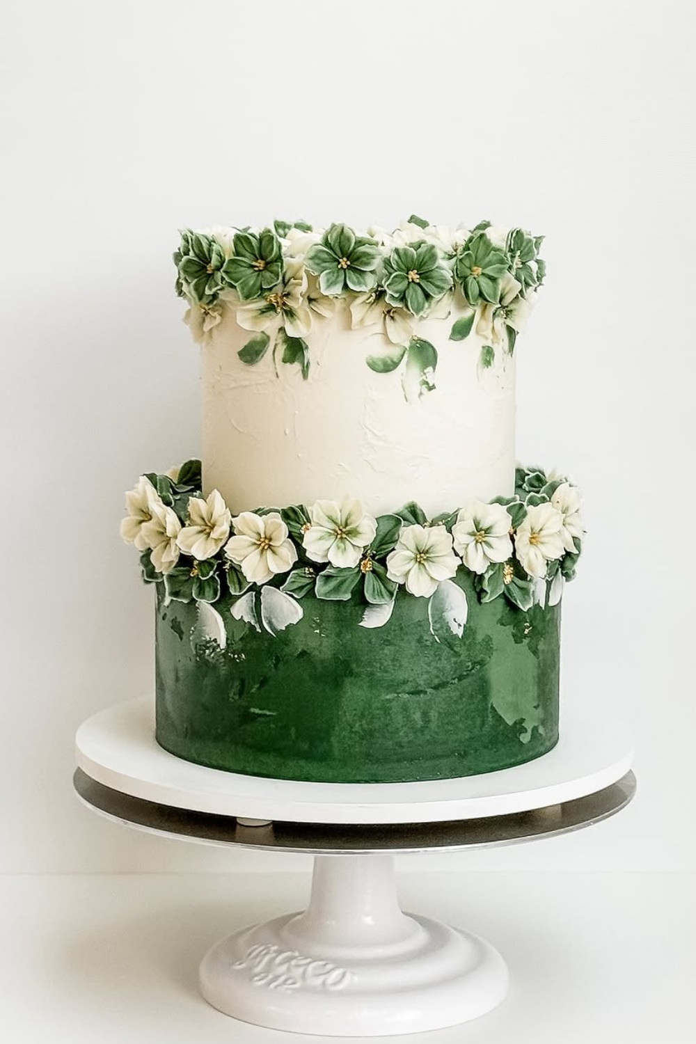 A 2-tier wedding cake design with white and emerald green