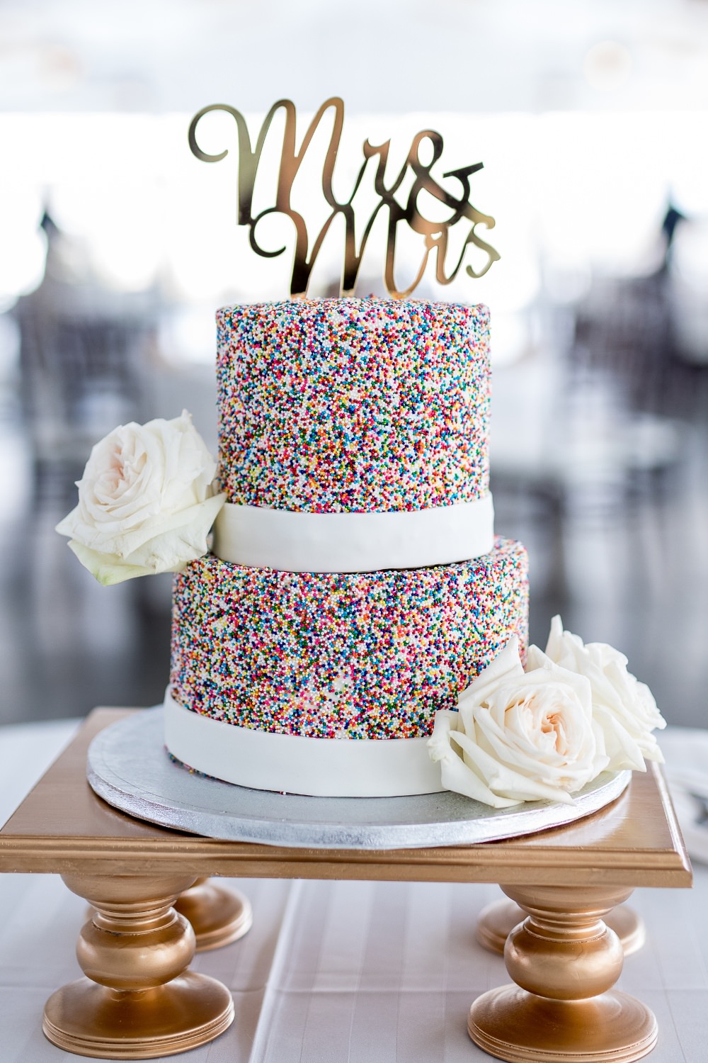 W 2-tier wedding cake covered in rainbow sprinkles