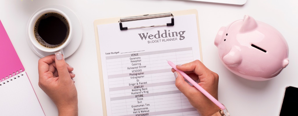 A woman filling out a wedding planner with a pencil