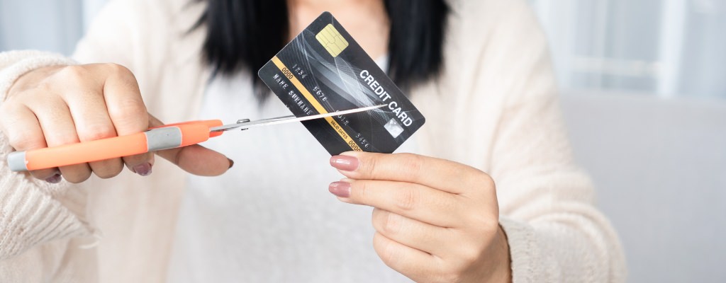 A woman cutting up a credit card