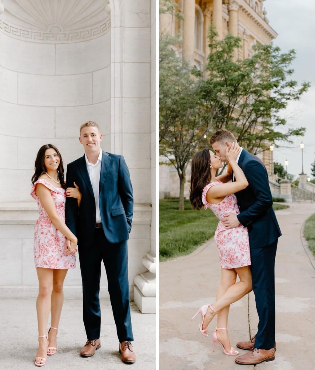 A man and woman posing for engagement photos in stylish outfits. She is wearing a short pink dress and he is wearing a suit