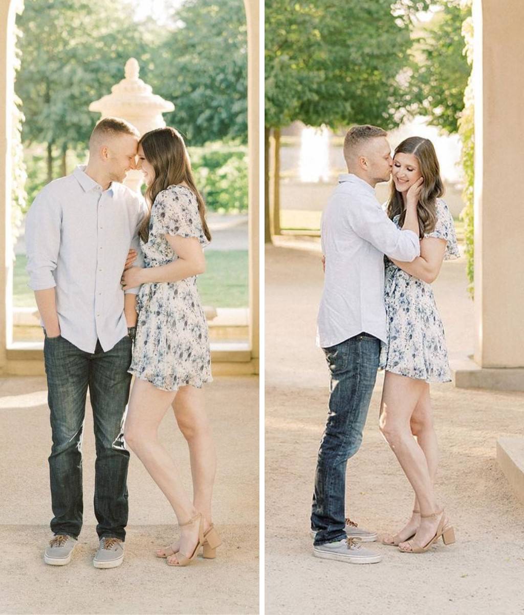 A couple posing for engagement photos wearing jeans/dress shirt and a short blue floral dress and heels