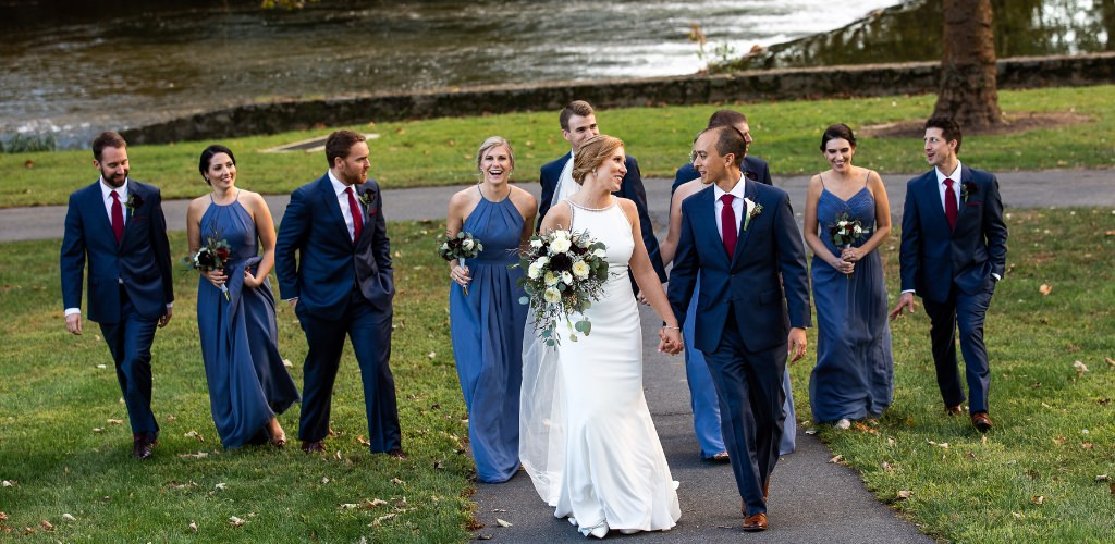 A bride and groom walking with the wedding party
