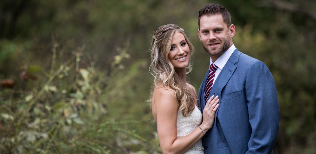 A bride and groom posing outside