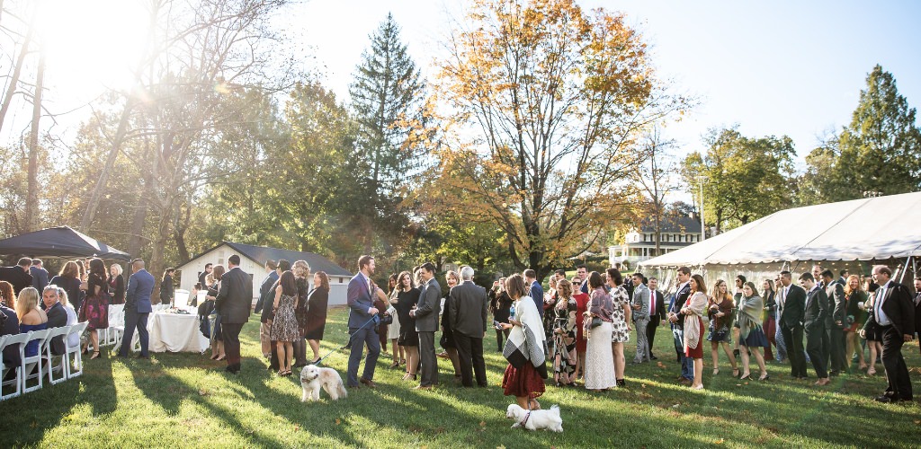 Wedding guests walking around outside during cocktail hour