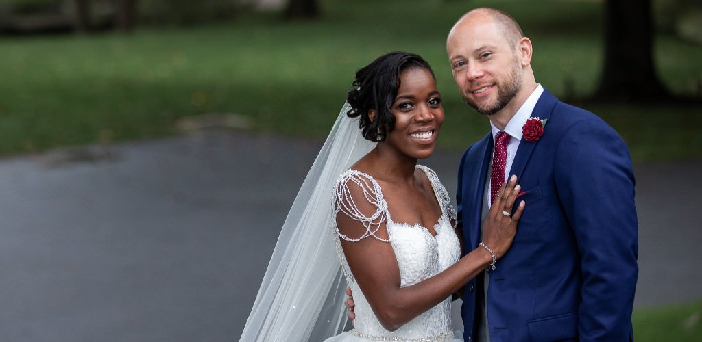A bride and groom posing for the wedding photographer
