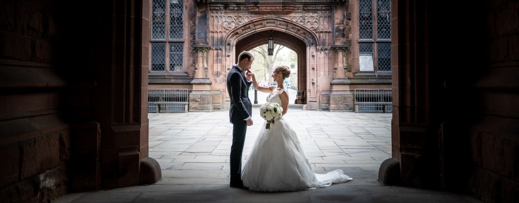 A groom kissing a bride on the hand