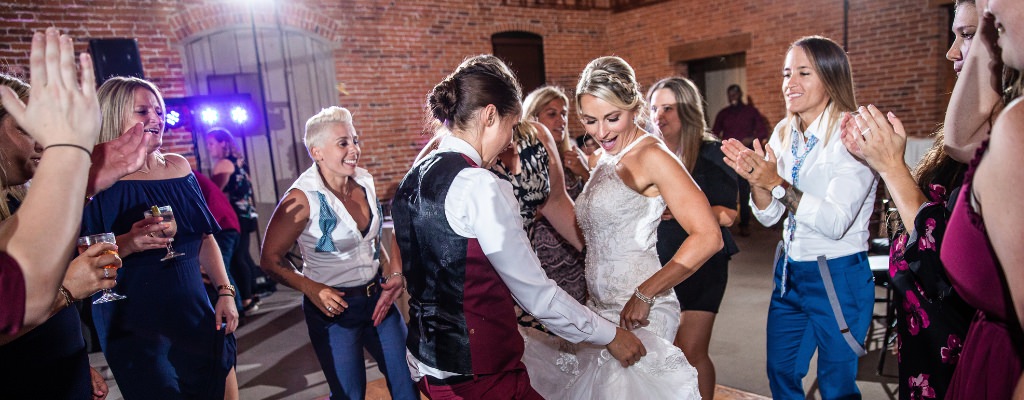 Two brides dancing together at the wedding reception