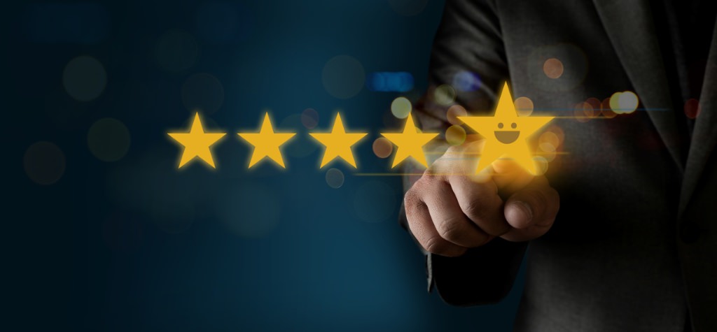 A finger pointing at online review stars