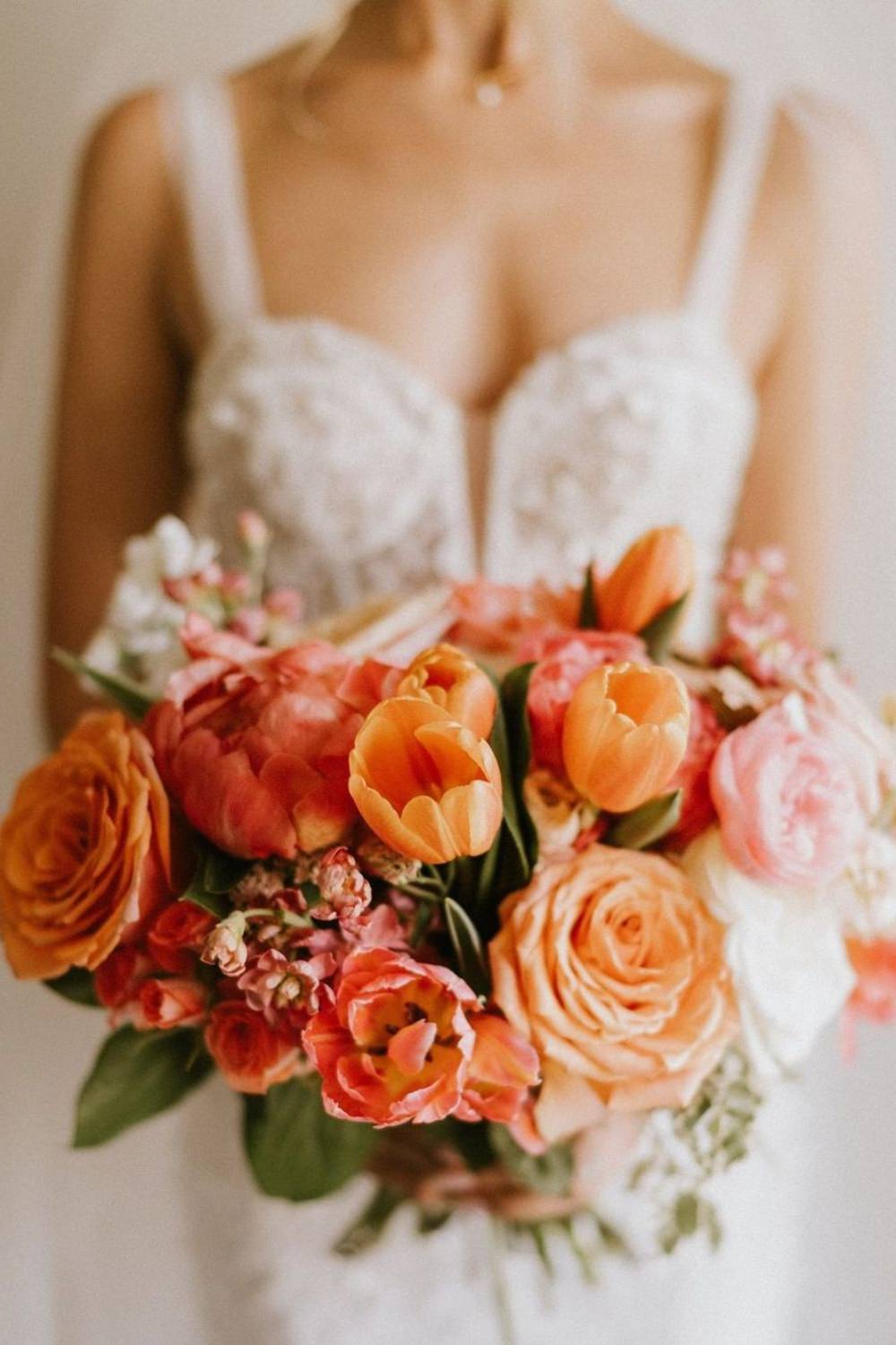 A stunning close up photo of an orange wedding bouquet