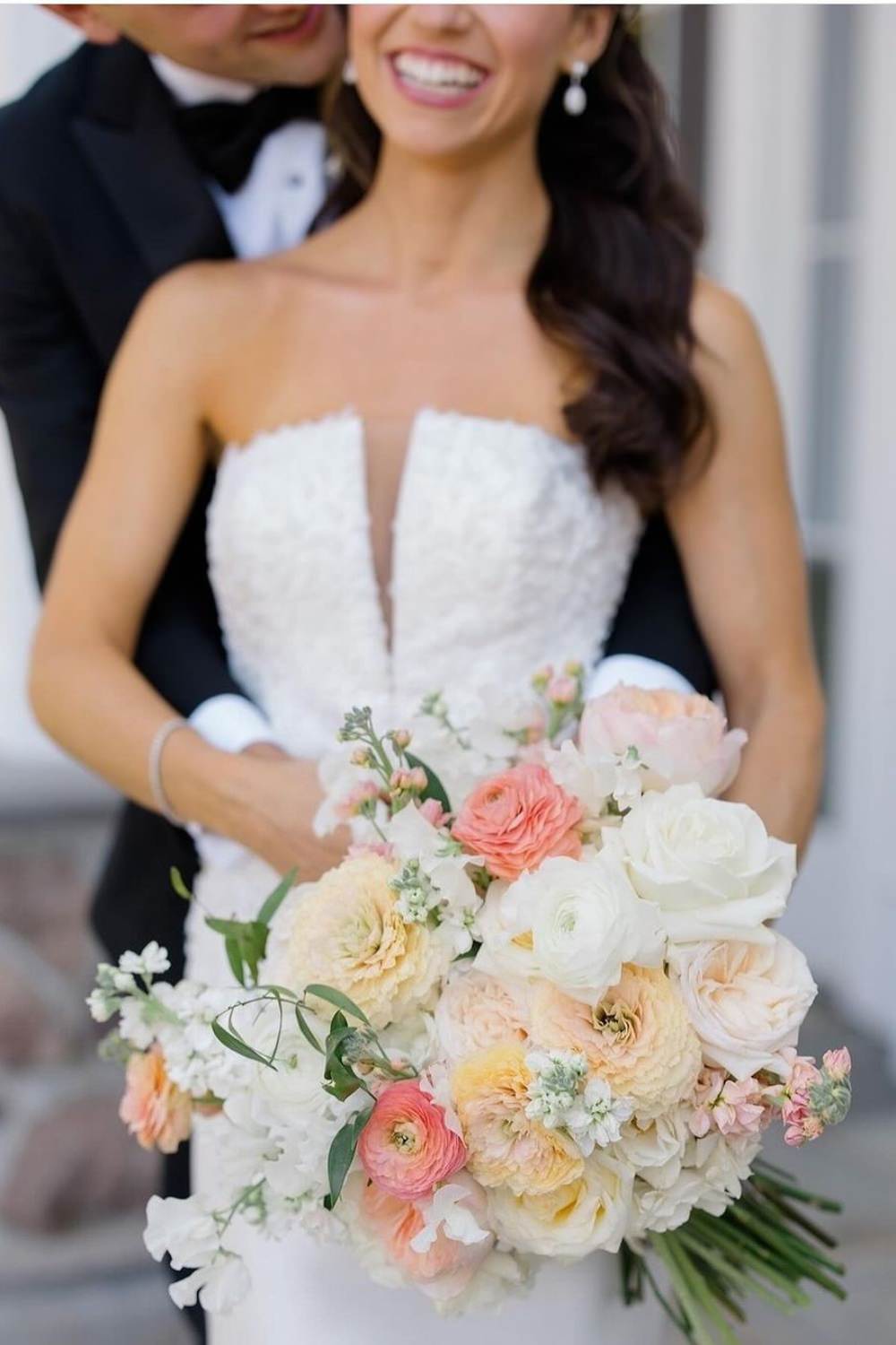 A gorgeous white and pink and peach wedding bouquet