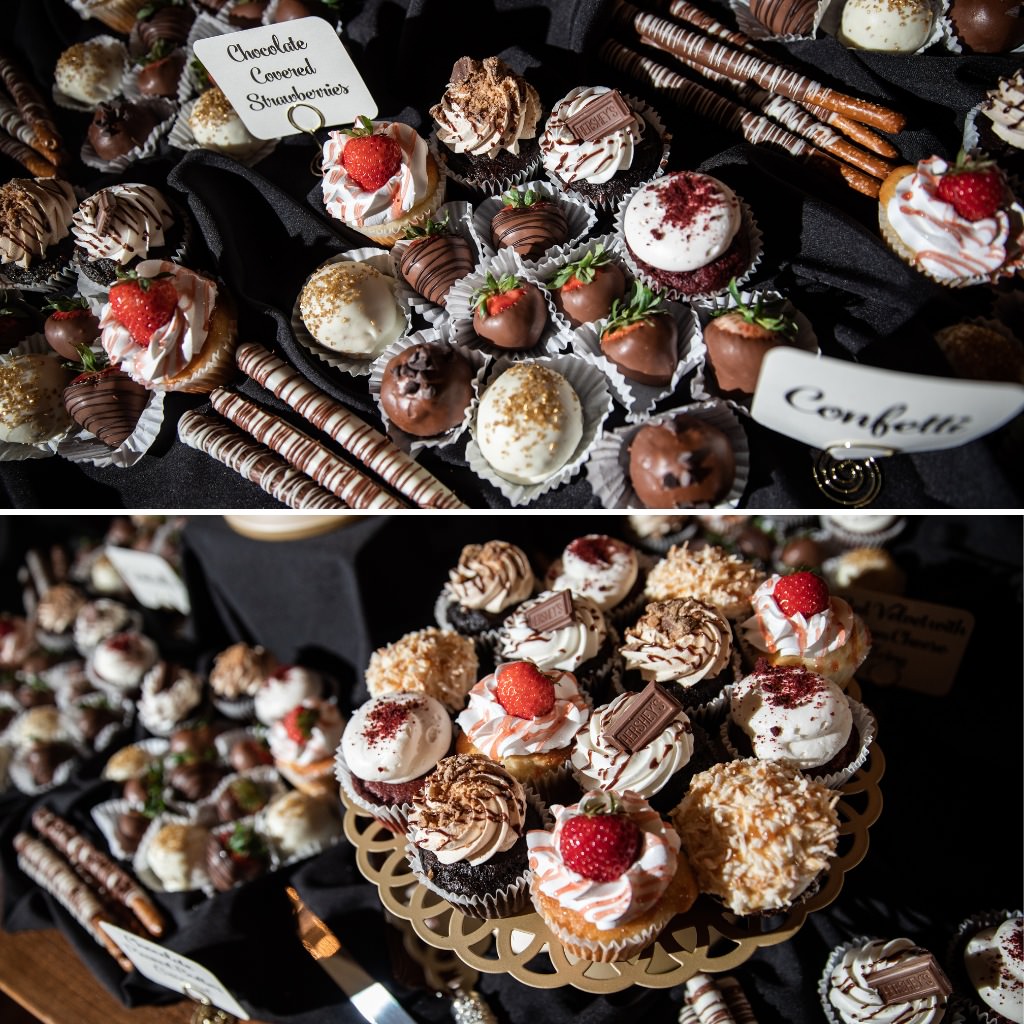 An assortment of wedding desserts like chocolate covered strawberries, chocolate dipped pretzel rods, and cupcakes
