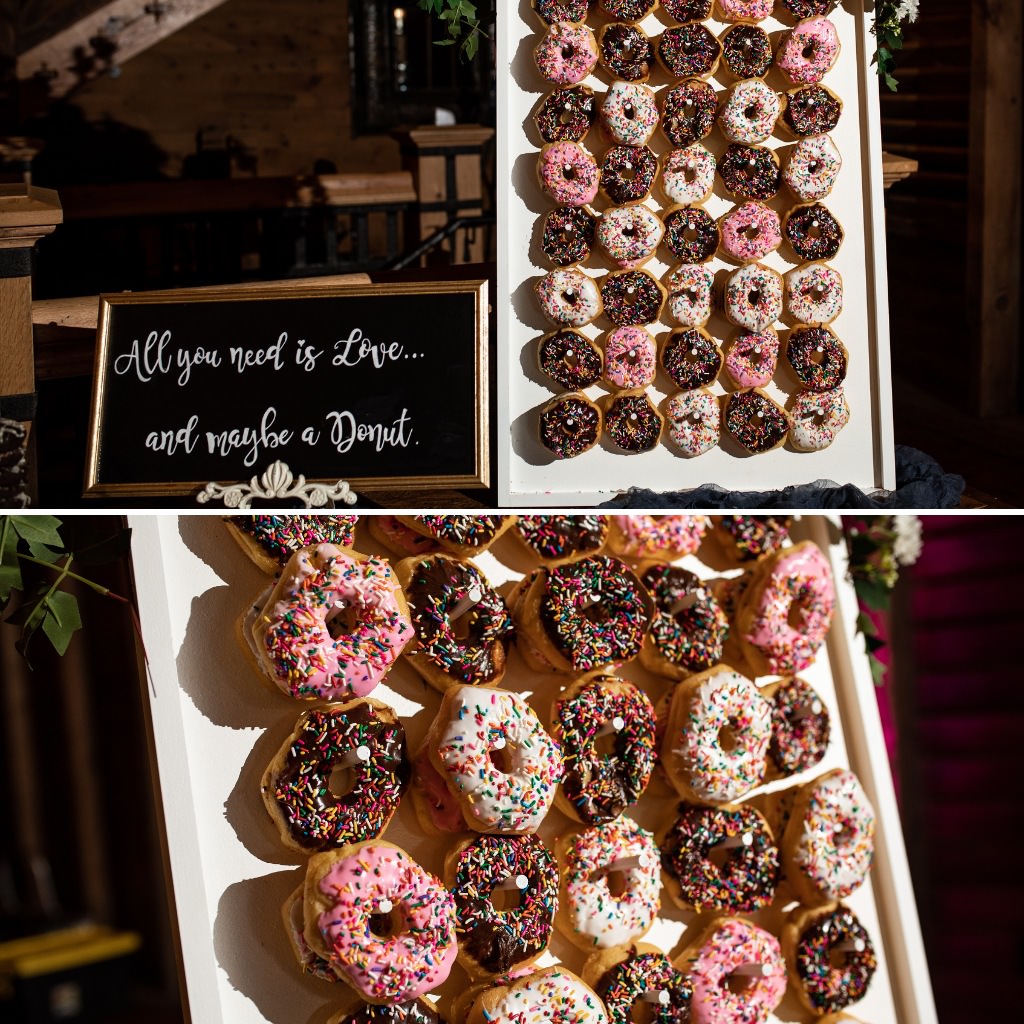 Pink, white, and chocolate donuts on a donut wall at a wedding reception.