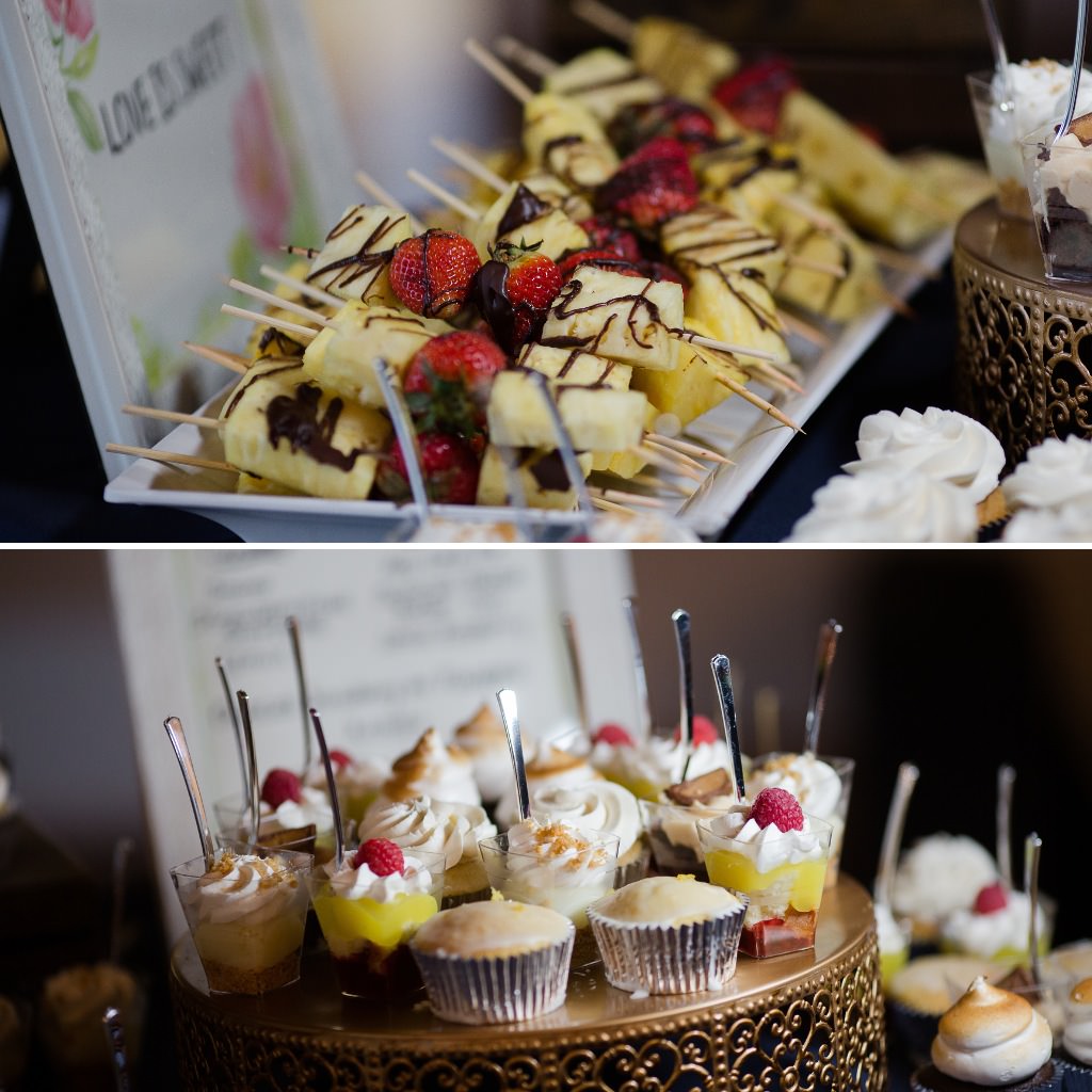 Fruit skewers and cupcakes on a wedding dessert table