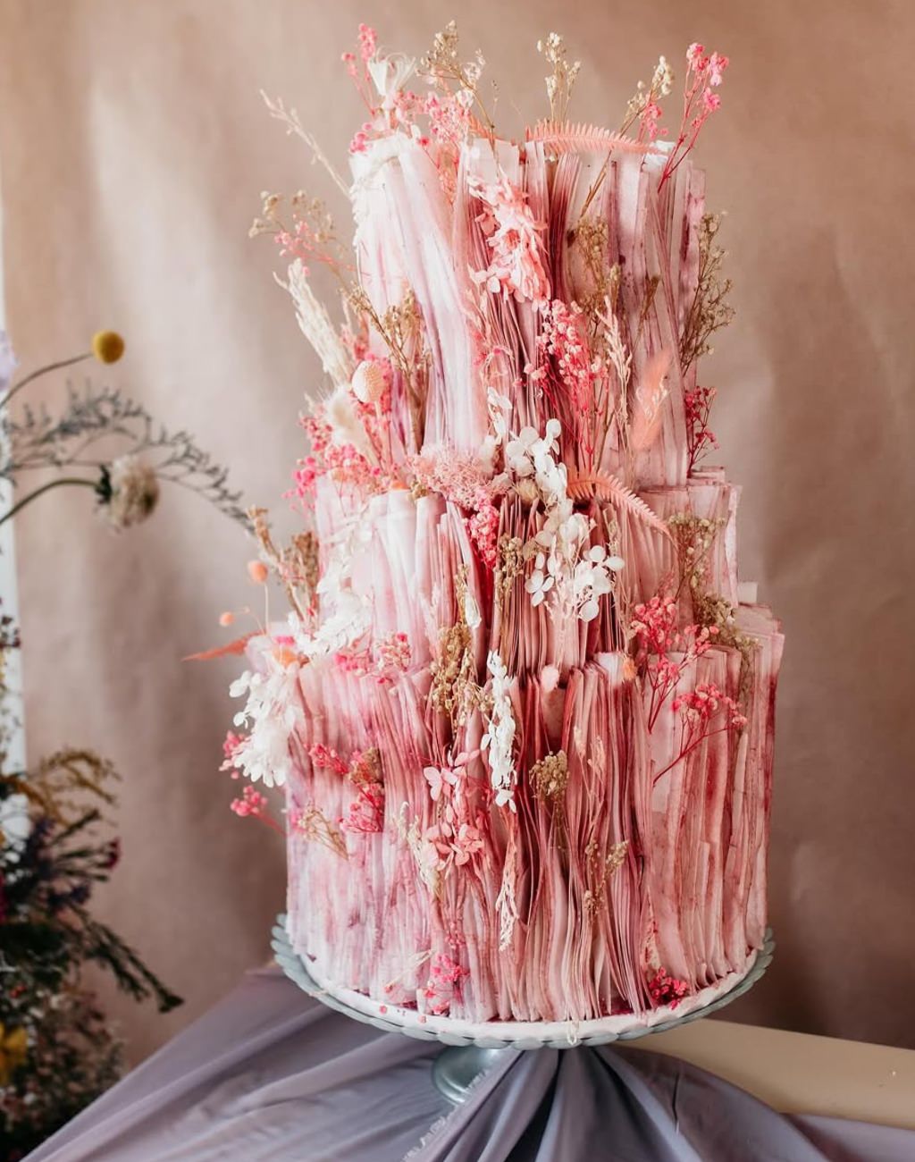 A gorgeous and unique pink red wedding cake with 3 tiers