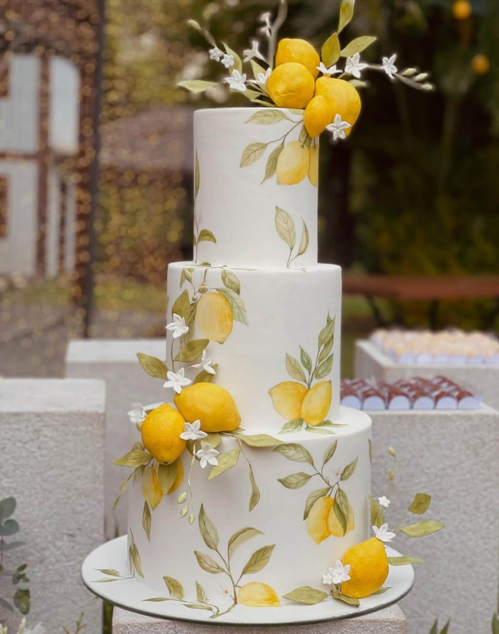 A gorgeous hand painted 3-tier wedding cake with lemon theme
